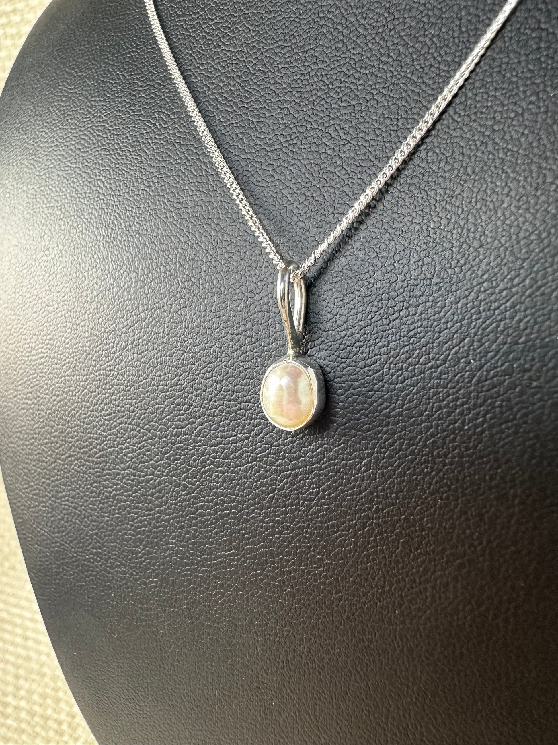 Fresh water pearl in a 925 sterling silver set bezel on a 925 sterling silver thin chain 