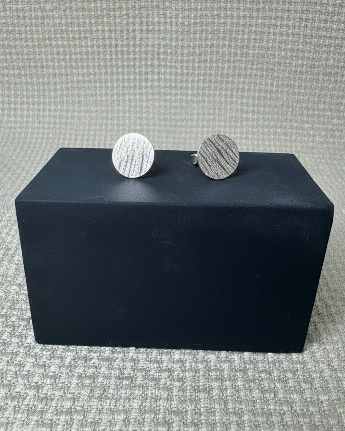 Round stud earrings with a stripy and rippled hammered texture. Made from recycled sterling silver.