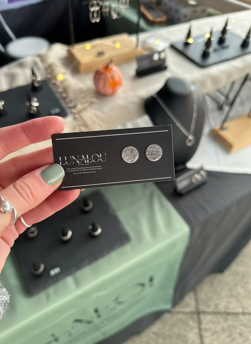 Round stud earrings with a stripy and rippled hammered texture. Made from recycled sterling silver.