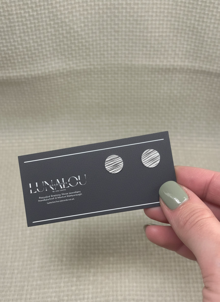 Round stud earrings with a stripy and rippled hammered texture. Made from recycled sterling silver.