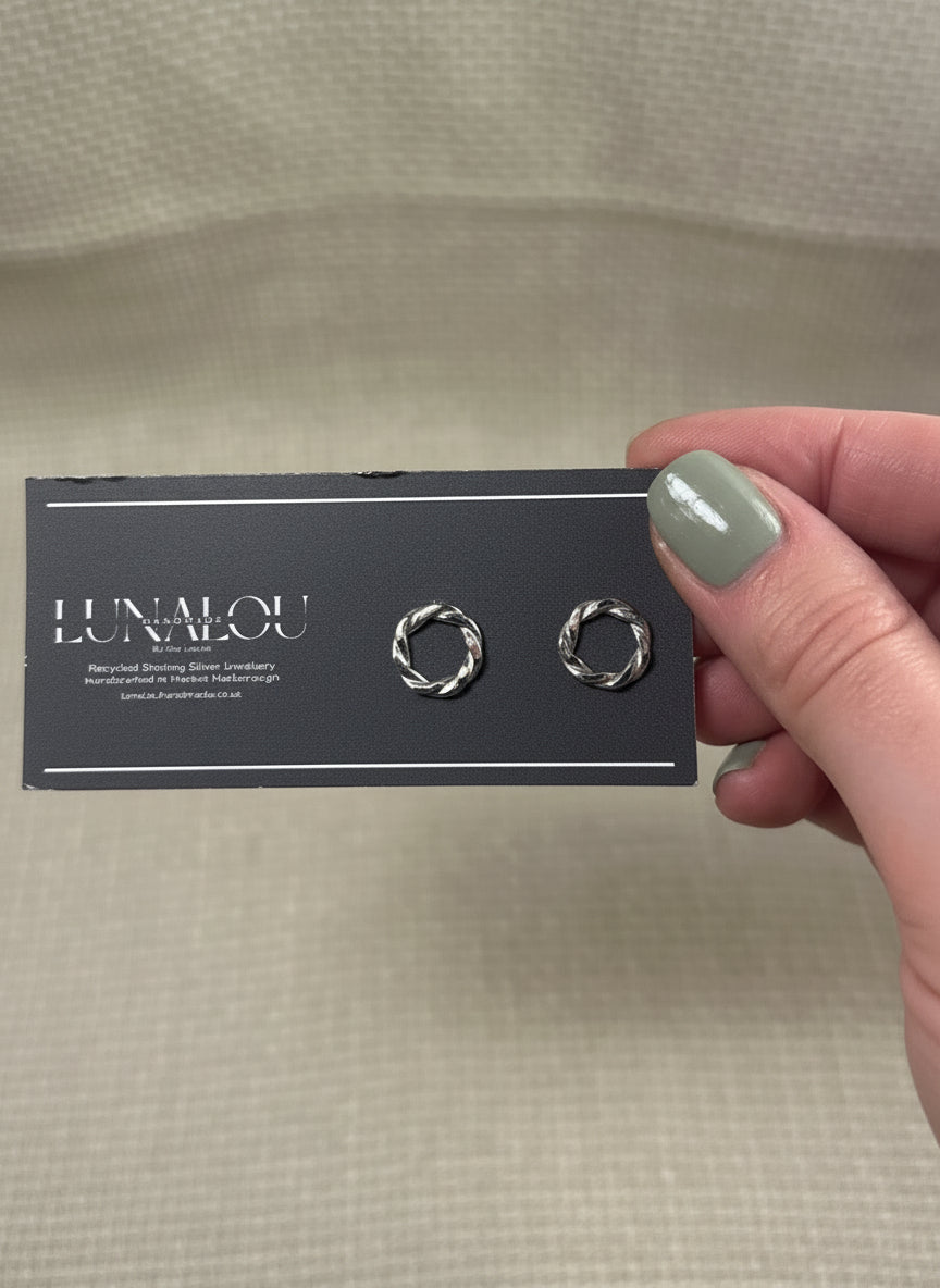 sterling silver earrings, round with a twisted ivy appearance. butterfly clasp