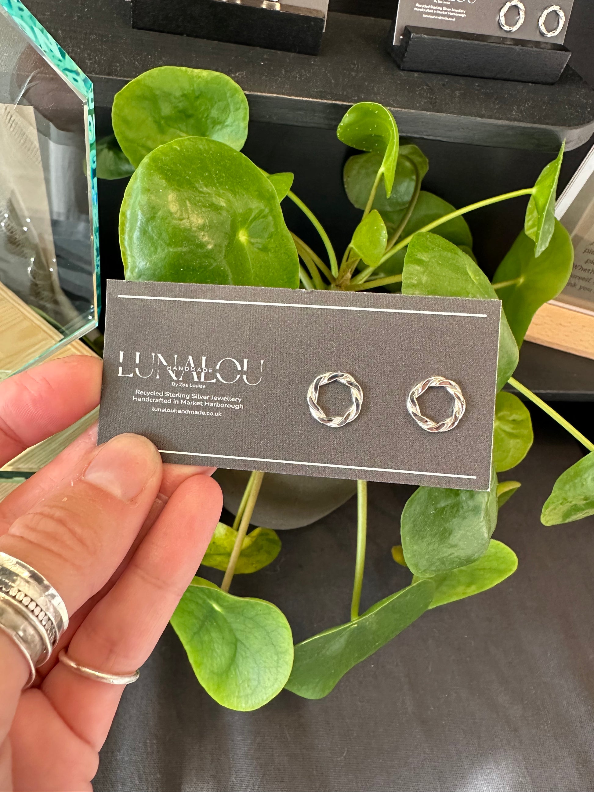 sterling silver earrings, round with a twisted ivy appearance. butterfly clasp