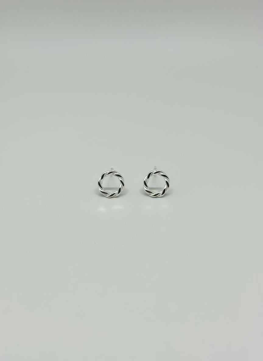 sterling silver earrings, round with a twisted ivy appearance. butterfly clasp