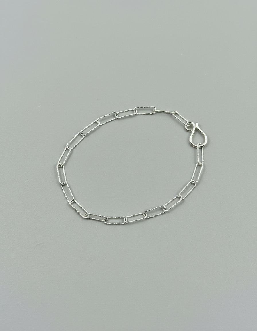 recycled sterling silver bracelet, sparkle chain bracelet, delicate silver bracelet, handmade silver jewellery, sustainable jewellery UK, fine chain bracelet, layering bracelet, dainty silver bracelet, eco friendly jewellery, ethical silver bracelet, minimalist bracelet, silver paper chain bracelet, slow fashion jewellery