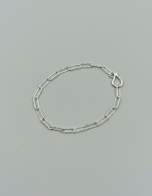 recycled sterling silver bracelet, sparkle chain bracelet, delicate silver bracelet, handmade silver jewellery, sustainable jewellery UK, fine chain bracelet, layering bracelet, dainty silver bracelet, eco friendly jewellery, ethical silver bracelet, minimalist bracelet, silver paper chain bracelet, slow fashion jewellery
