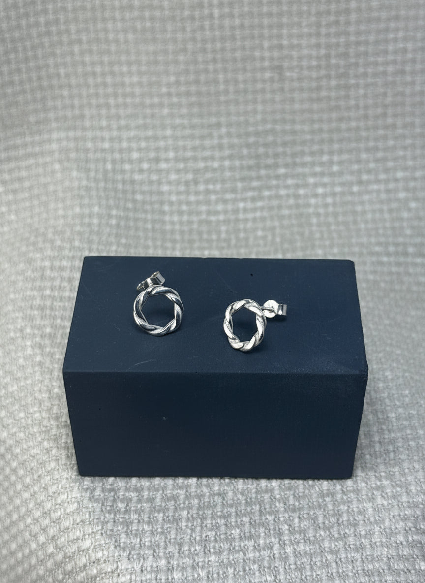 sterling silver earrings, round with a twisted ivy appearance. butterfly clasp